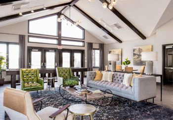 a living room with couches and chairs and a rug at The Timbers Apartments, Evansville